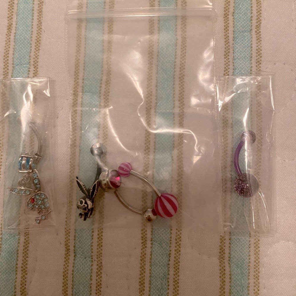 Body Candy 14G Playboy Bunny rings package blue, black/magenta, and purple ring